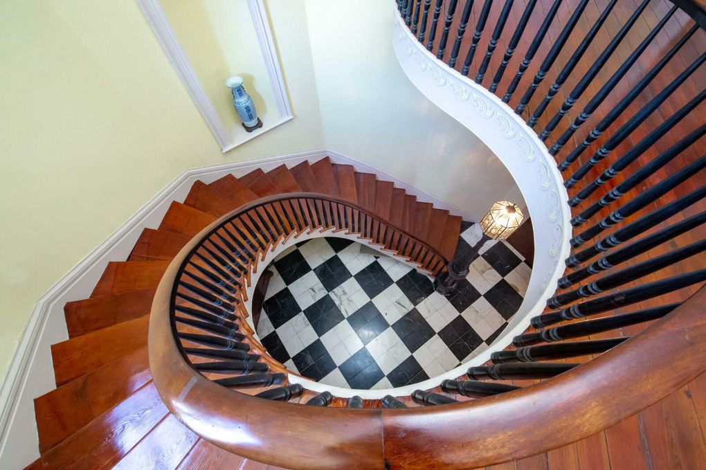 Stairs leading to the second floor of La Mode Duncan headquarters, 26 South Battery, Charleston SC, in the novel The Boutique Robillard. Actually the Colonel John Algernon Sydney Ashe House.