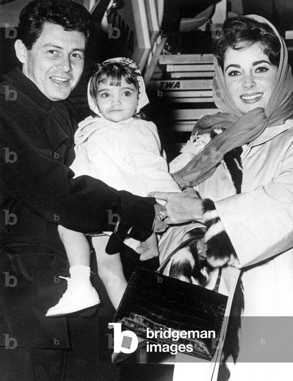 1959 11th September, New York, at Idlewild Airport. Elizabeth Taylor and Eddie Fisher have just returned from a four-month honeymoon in Europe. With two-years-old Liza, Christopher and Michael Wilding. 
