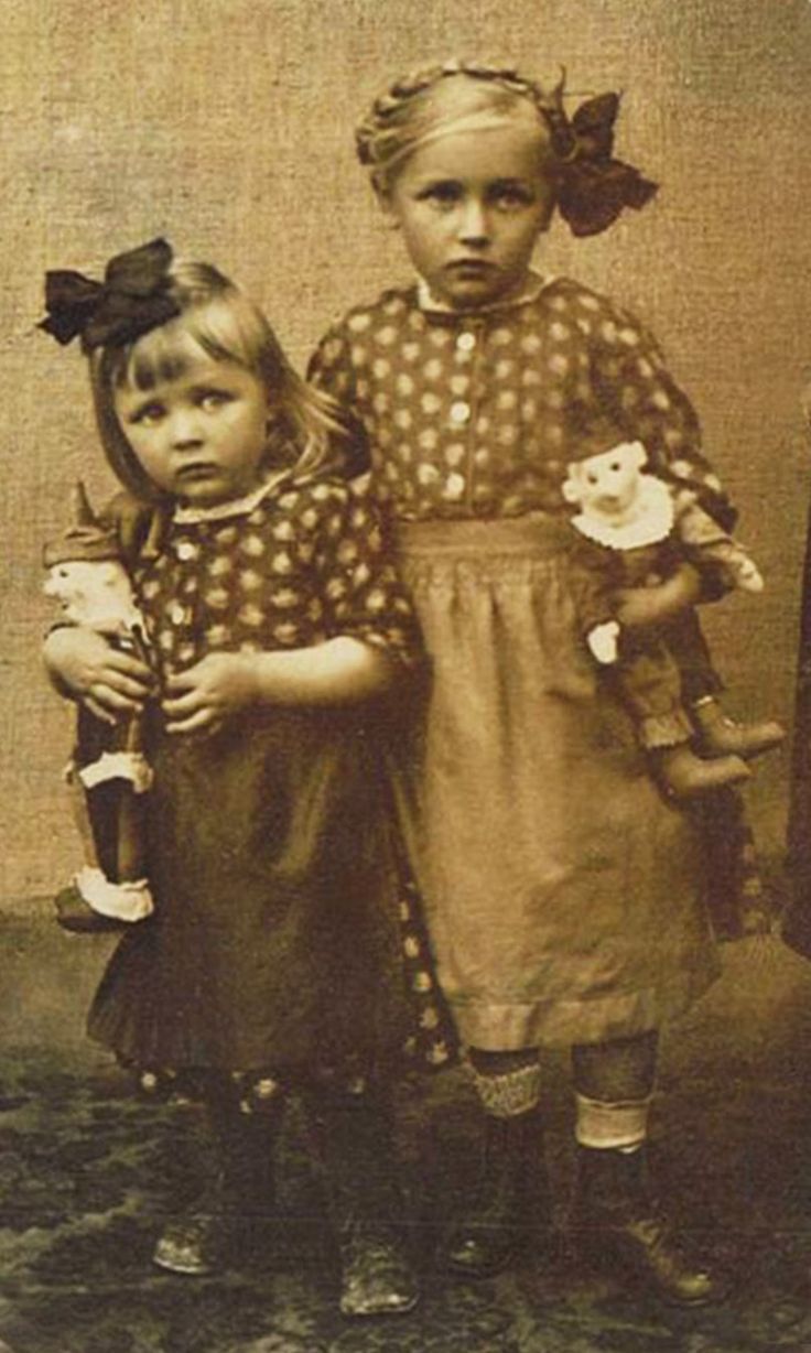 Sisters with dolls.