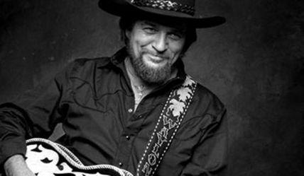 June 15th 1933, Born on this day Waylon Jennings. Jennings worked as a DJ, played bass with Buddy Holly, Jennings unintentionally missing flying with Holly, The Big Bopper and Ritchie Valens on the flight on which they died. In 1976 he released the album Wanted! The Outlaws with Willie Nelson, Tompall Glaser and Jessi Colter, which became the first platinum country music album, and he was also a m