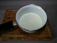 1 - Réunir vos ingrédients. Nettoyer, laver et éponger les calamars. Faire chauffer dans une casserole du lait et le verser bouillant sur la mie de pain émiettée. Bien écraser et malaxer à la fourchette. Peler, hacher l'oignon et l'ail, en réserver une moitié de chaque pour la suite de la recette. Découper le jambon cru en petits morceaux, en garder 2 tranches sans les découper pour la décoration.