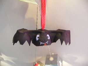 boîte à oeufs coupée en deux, peinture noire ou violette et dessin des yeux et de la bouche, un tit ruban et bouhh la chauve souris qui fait trop trop peur.. ou pas...