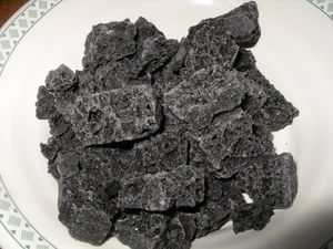 En haut, la Befana ; à gauche, une chaussette de bonbons ; à droite, le charbon (le charbon est comestible, il est constitué essentiellement de sucre et, est très bon)