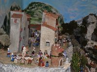 Yves et sa crèche évoquant les activités de son village natal, Tourettes sur loup capitale provençale de la violette.