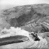 A Priest 105mm self-propelled gun negotiates a hairpin bend on a mountain road near Mondaino during the advance through the Gothic Line, Italy, 6 September 1944. NA18392.jpg