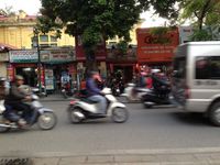 Ordinary days in the streets of Hanoi with the door of my hostel and the free breakfast they served.