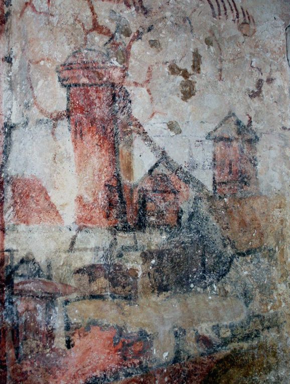 Les ruines du donjon et une peinture du donjon figurant sur un des murs de l'église