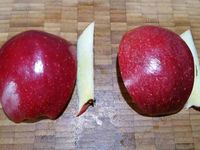 2 - Peler le kiwi, couper les deux extrémités, puis couper en 2 dans le sens de la longueur et en tranches moyennes. Laver et couper la pomme en deux, puis en quarts. Oter le trognon de 2 quartiers et les tailler en feuille comme sur la photo et bien citronner pour éviter l'oxydation de la pomme. Laver et équeuter les fraises et les couper en lamelles dans le sens de la hauteur. Laver et peler le kaki, le couper en quarts et tailler en fines tranches.   