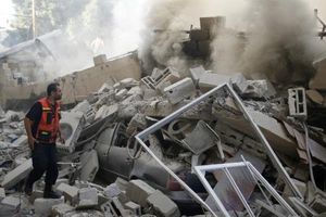 A Palestinian firefighter participates in efforts to put out a fire from the wreckage of a house