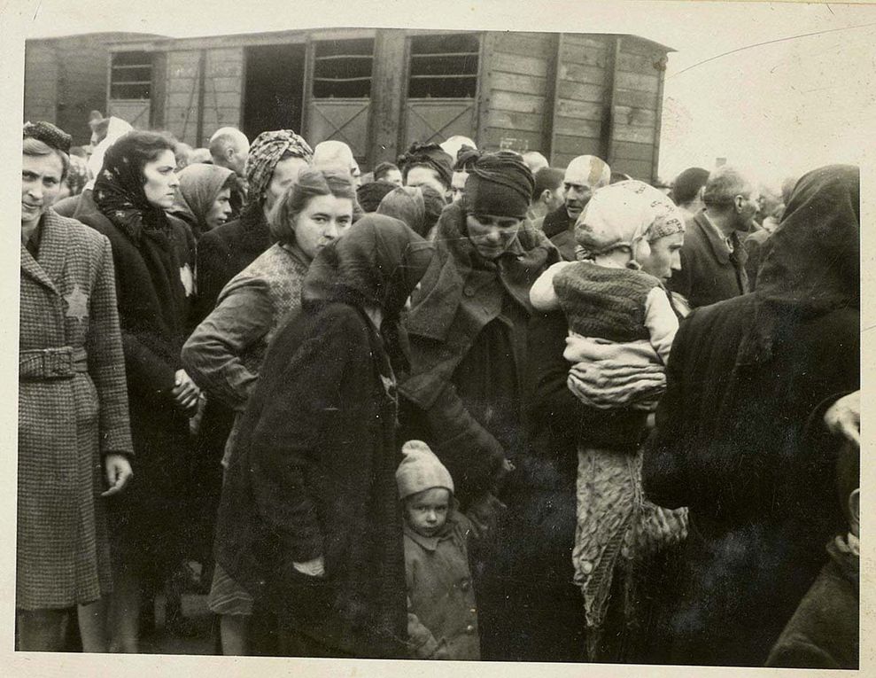 In the photos we see the men, women and children step out of the overcrowded train, traumatized and fearful after their horrendous journey. They have no clue that they have just been delivered to a death factory and that few of them will survive.