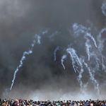 Tear gas canisters are fired by Israeli troops at Palestinian 