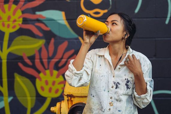 woman-drinking-water-from-insulated-water-bottle