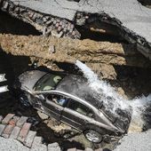 Ohio sinkhole swallows car; driver climbs ladder