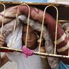 A displaced Palestinian carries his belongings as he leaves a United Nations school