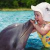 Very Cute and Beautiful Kid with Little Dolphin