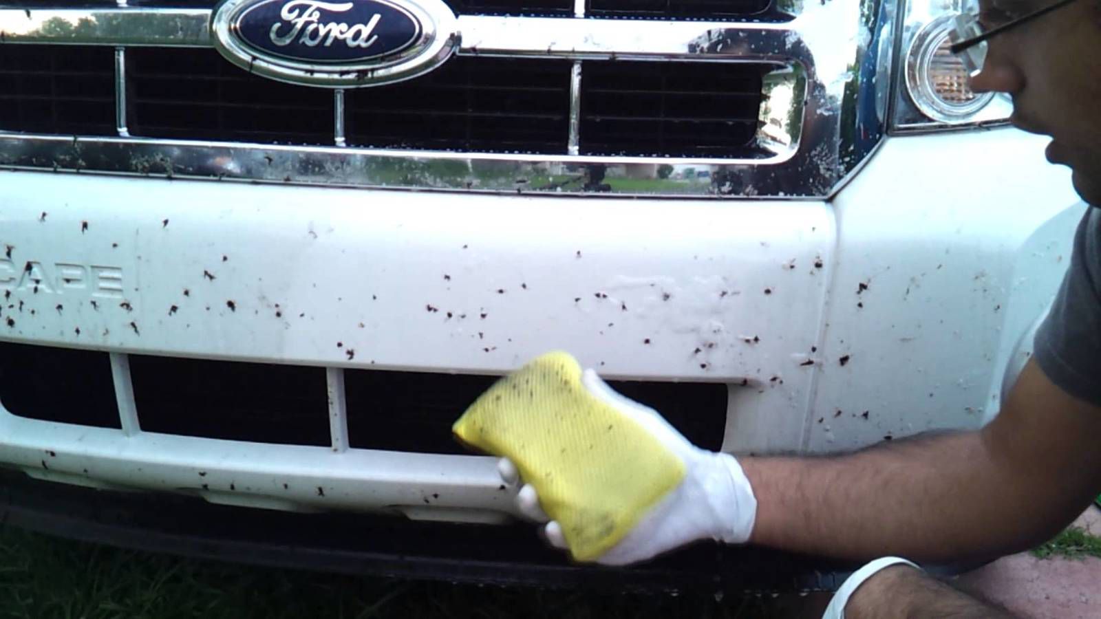 A man using one of the best tar remover for cars to clean his vehicle 