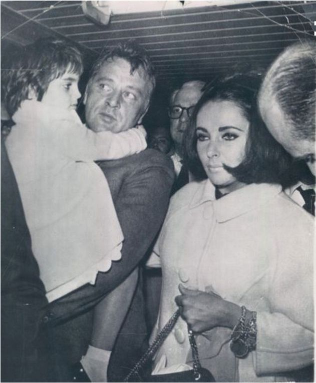 September 22 1963, brief stop in Toronto before flying to Mexico. Elizabeth Taylor, Richard Burton, and Liza Todd on his lap - September 23 1963, Mexico airport: Elizabeth Taylor keeps her arm tightly around Richard Burton as Liza Tood clings to his neck on arrival at the airport. The stars were besiged by a pressing throng. Arrival at Mexico airport. From one plane to another: Liza Todd with her mother Elizabeth Taylor. 