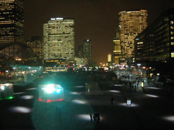 <P><STRONG>Images volées la nuit, dans l'un des quartiers les plus défigurés d'Île de France, la Défense</STRONG>. Des Tours immenses surplombent&nbsp;des sculptures fantomatiques, entourant une arche colorée par des spots rouge et vert. Au milieu d'une place, une écran de télévision géant diffuse des publicités aux travailleurs-passants.</P>
<P><STRONG>Ambiance "Blade Runner" assurée</STRONG>, il ne manquerait plus qu'une musique symphonique macabre pour couronner le tout.&nbsp;Pourtant, <STRO