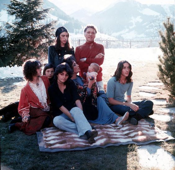 1972, Gstaad - Elizabeth Taylor holds her grandchild. Still a happy family: Richard Burton, Liza, Maria, Christopher, Michael and his wife.