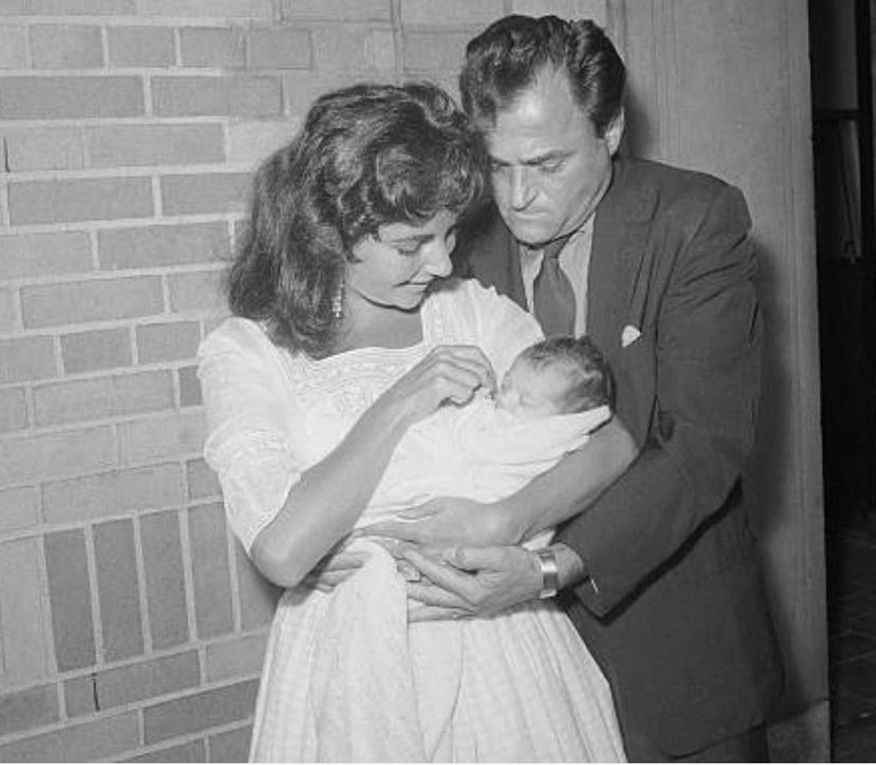 1957, September 3, AP wire release:  - New York - Liza makes camera debut - Mike Todd lends a helping hand as little Liza Todd leaves Harkness Pavilion hospital here today in the arms of her mother, actress Elizabeth Taylor. The parents came here from their Connecticut home to pick up Liza, born prematuraly August 6. (AP Wirephoto)