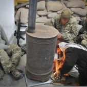 Emanuel Zamai, a member of the Afghan Uniformed Police(AUP) in the city of Gardez, gets a fire started for U.S. Army scouts from Headquarters and Headquarters Company, 3rd Battalion, 509th Infantry Regiment 120216-A-ZU930-014.jpg