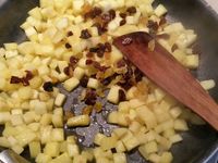 2 - Dans une poêle, faire chauffer le beurre, le sucre roux et le jus du 1/2 citron. Y verser les morceaux de fruits et laisser poêler 3 mn sur feu vif, rajouter les raisins secs macérés et le rhum. Mélanger et laisser encore 1 mn sur le feu.