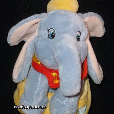 Doudou peluche éléphant Dumbo Disneyland Disney,dans une sac jaune,cigogne.