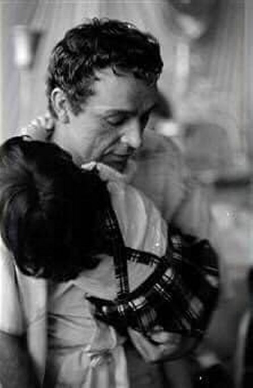 While talking to Elizabeth Taylor, Richard Burton holds Liza Todd on his lap. 